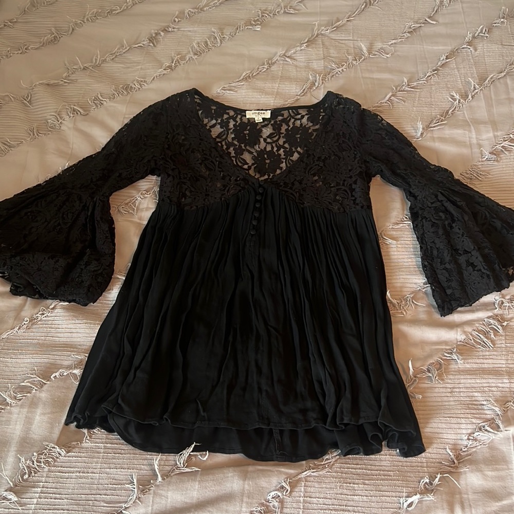 Lacy top with bell sleeves.